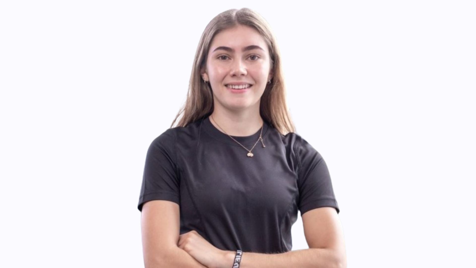 student headshot facing camera smiling with arms folded